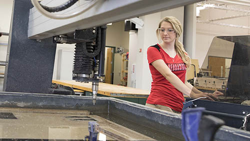 An engineering student operates equipment.
