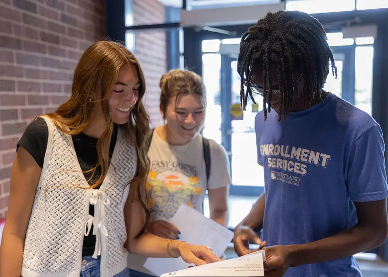 Students meeting with an enrollment services staff member