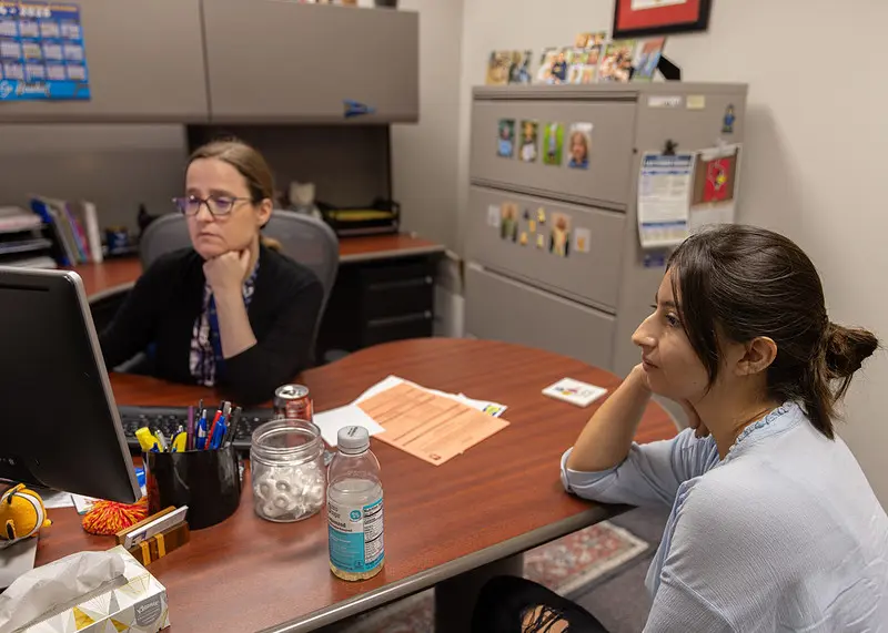 Student meeting with a staff member in an office