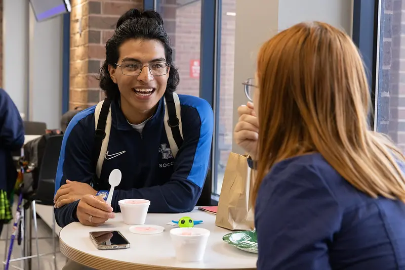 Student speaking with a classmate