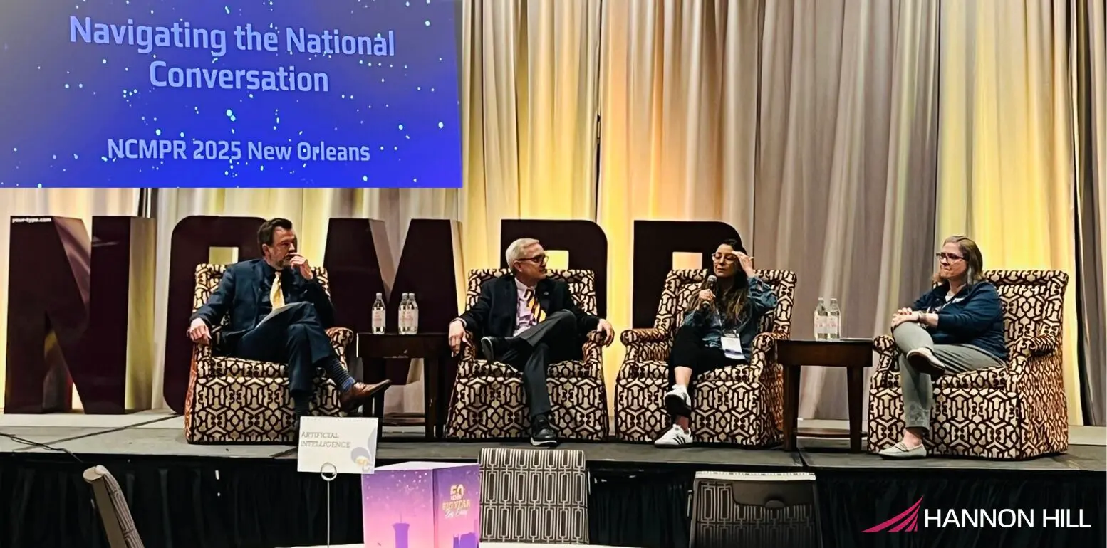 Panel discussion at the NCMPER conference in New Orleans, featuring three speakers on stage sharing insights and engaging with the audience.
